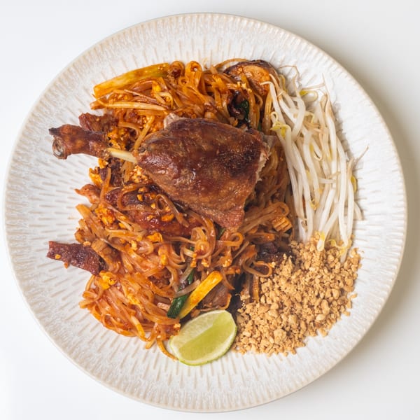 KorKai Thai Restaurant's duck Pad See Ew with bean sprouts, crushed peanuts, and lime.