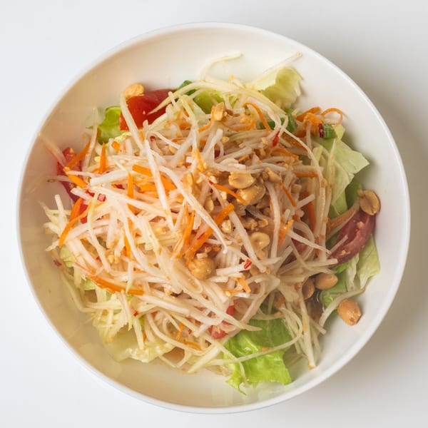 KorKai Thai Restaurant's Som Tum (papaya salad) with shredded papaya, carrots, tomatoes, and peanuts.